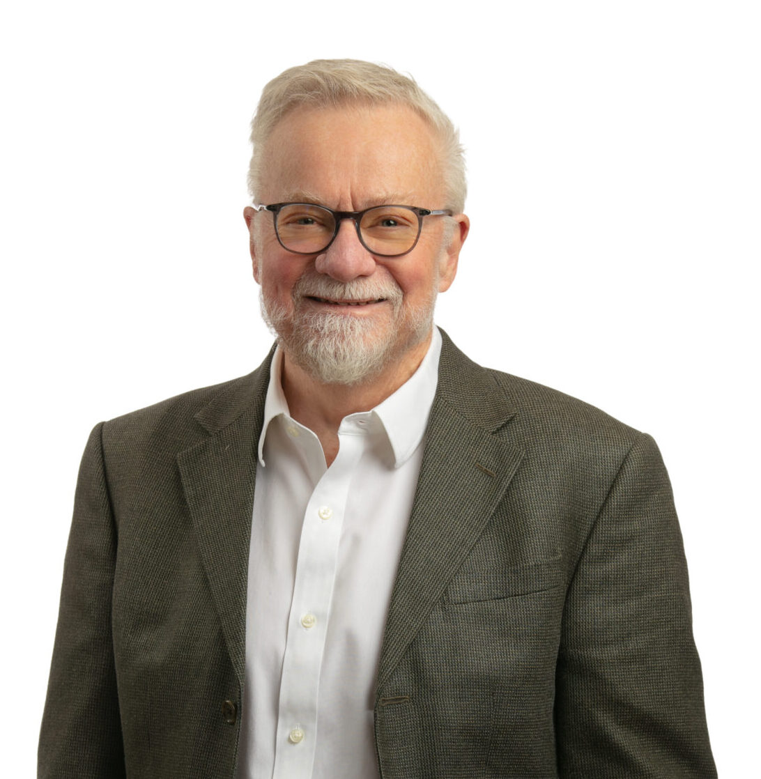 Professional headshot of Mark Spurr, Principal, standing and smiling.