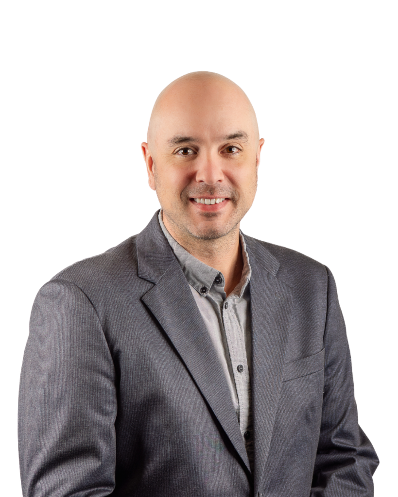 Professional headshot of Andrew Young, Engineering Manager, standing and smiling.