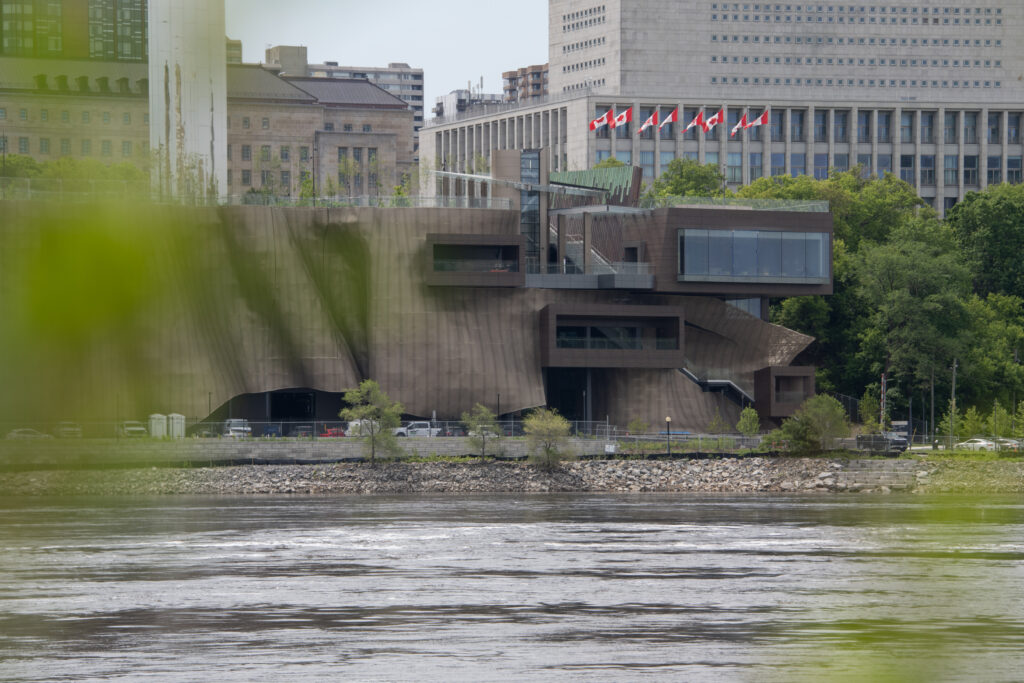 The Cliff Heating and Cooling Plant in Ottawa viewed from across the Ottawa River, with federal buildings visible in the background.