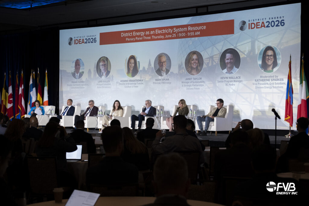 Panel of industry leaders speaking on stage during the IDEA2026 opening plenary in Ottawa, with a large presentation screen and audience in the foreground.