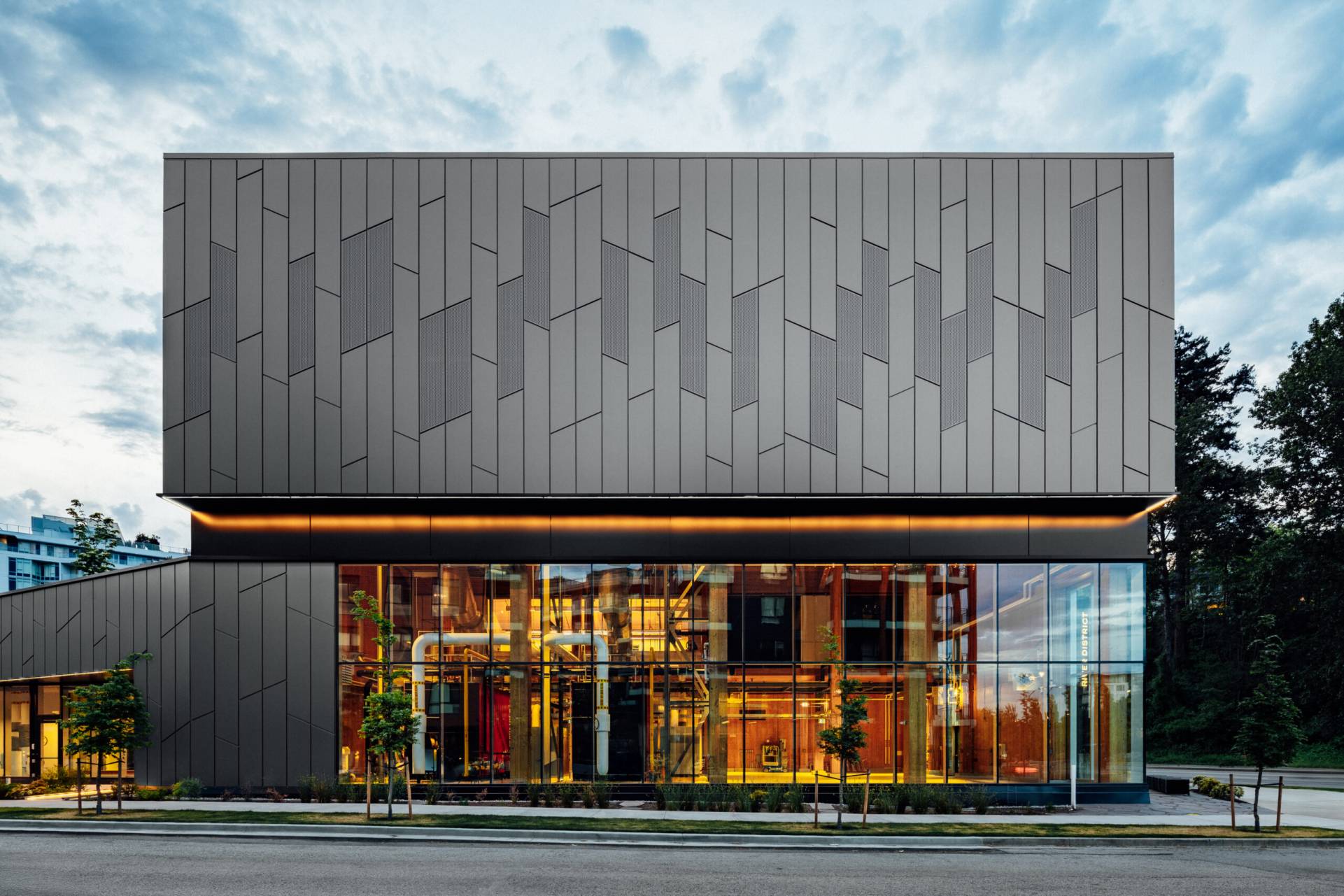 River District energy centre with patterned exterior and visible interior equipment

