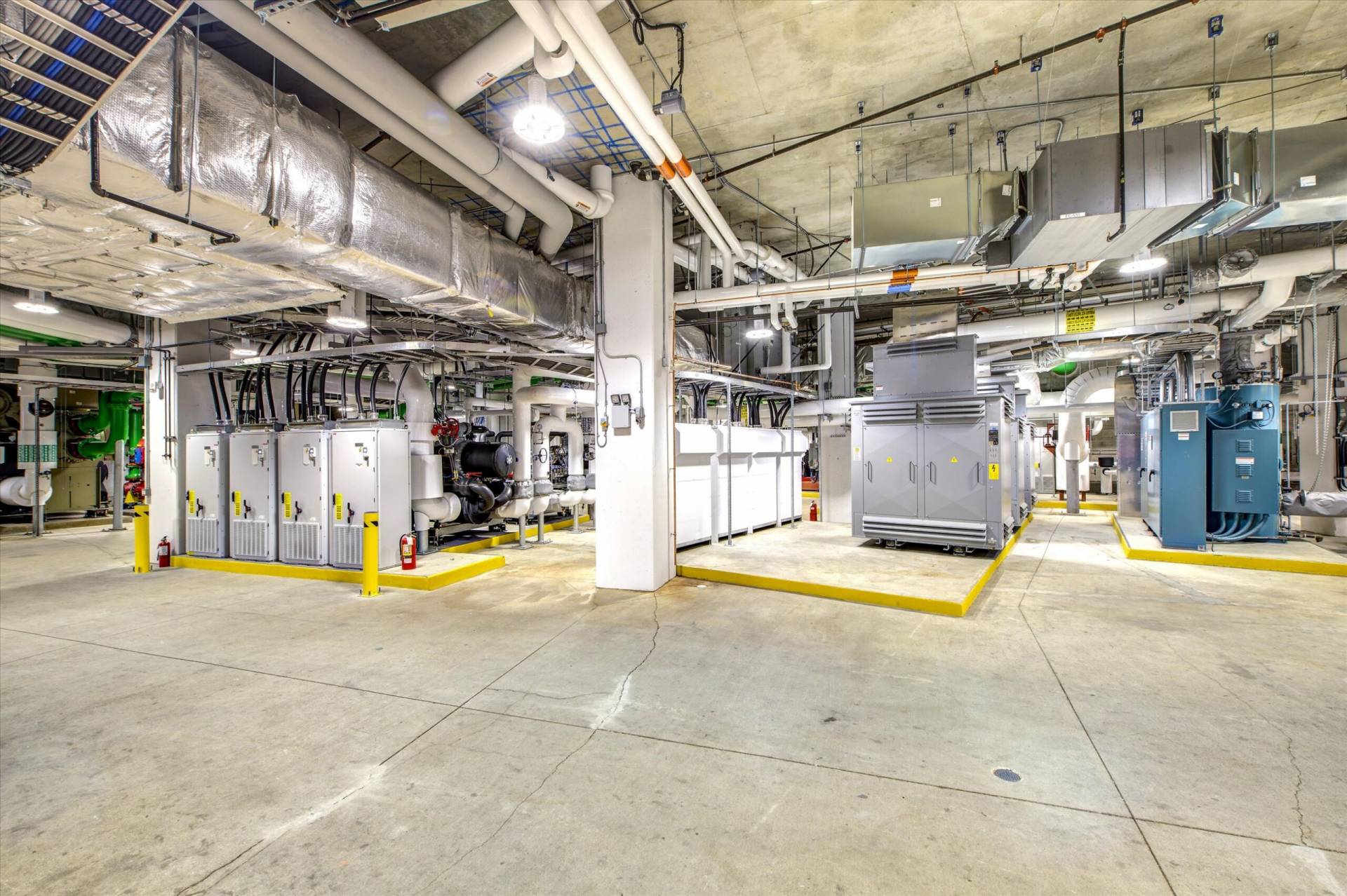 Mechanical plant room with energy equipment, piping, and control units at the Oakridge Centre Redevelopment.