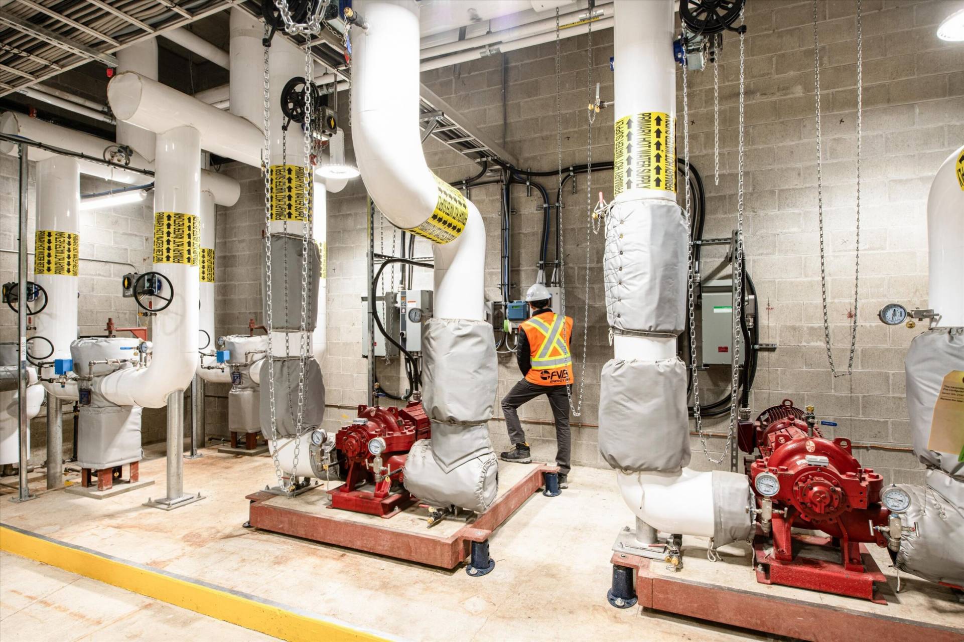 Mechanical room with piping and pump systems at the Oakridge Centre Redevelopment.